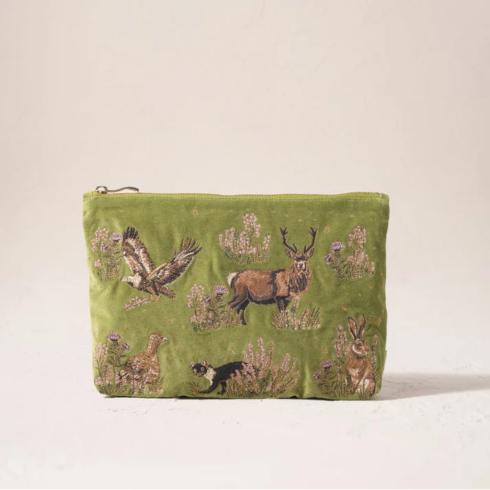 An olive green velvet pouch featuring embroidered woodland animals including a deer, owl, rabbit, and bird, set against a plain off-white background.