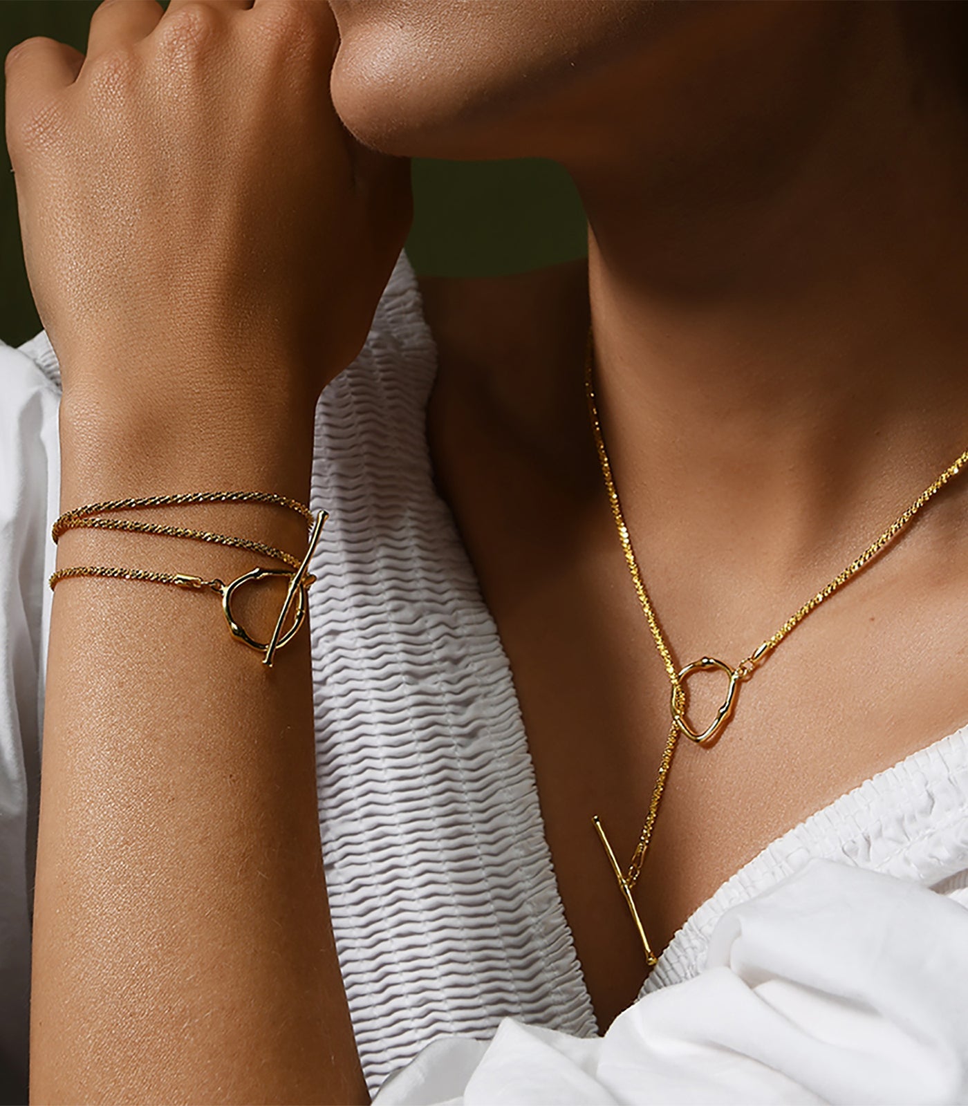 A gold vermeil toggle clasp necklace paired with a matching bracelet.