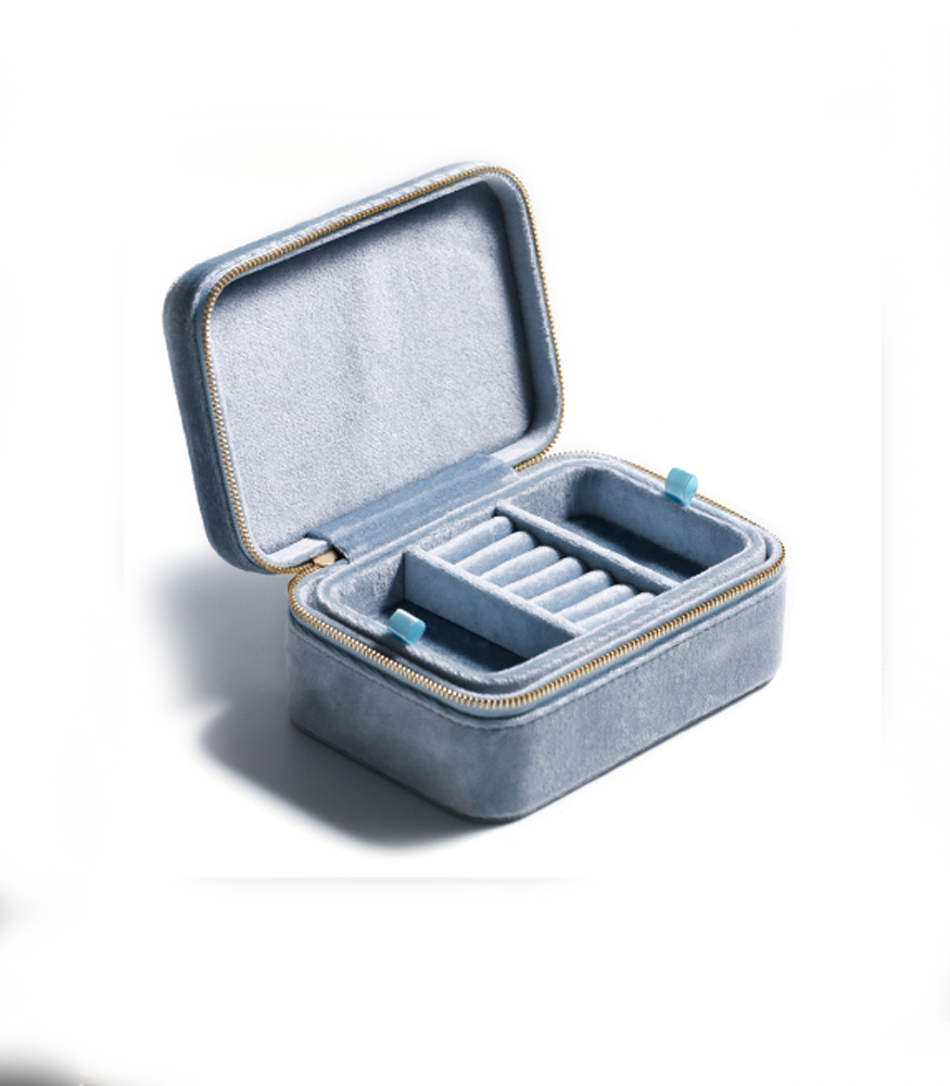 A light blue velvet jewellery storage box. The box is rectangular with a zip fastening and two layers.