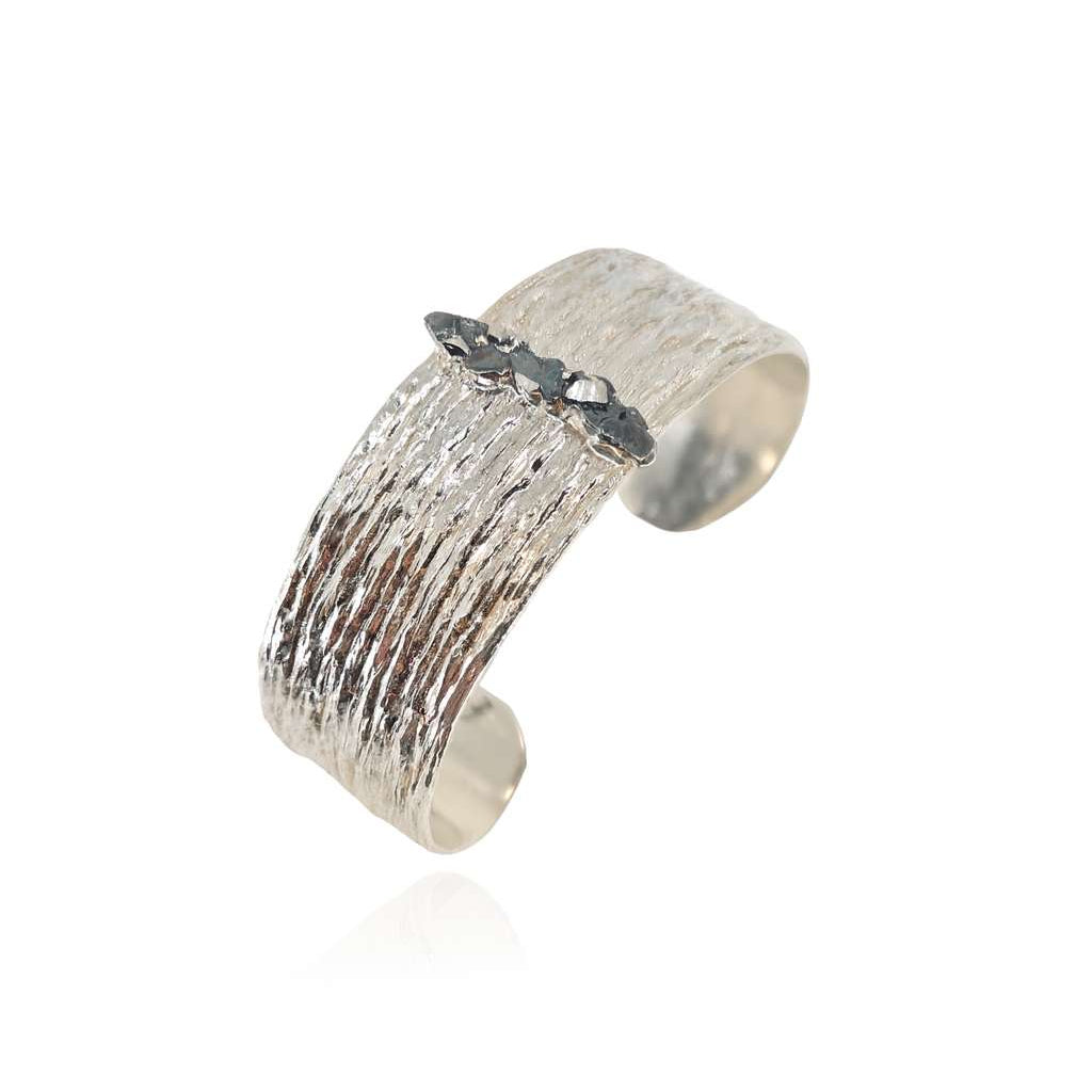 Silver textured cuff bracelet on a white background