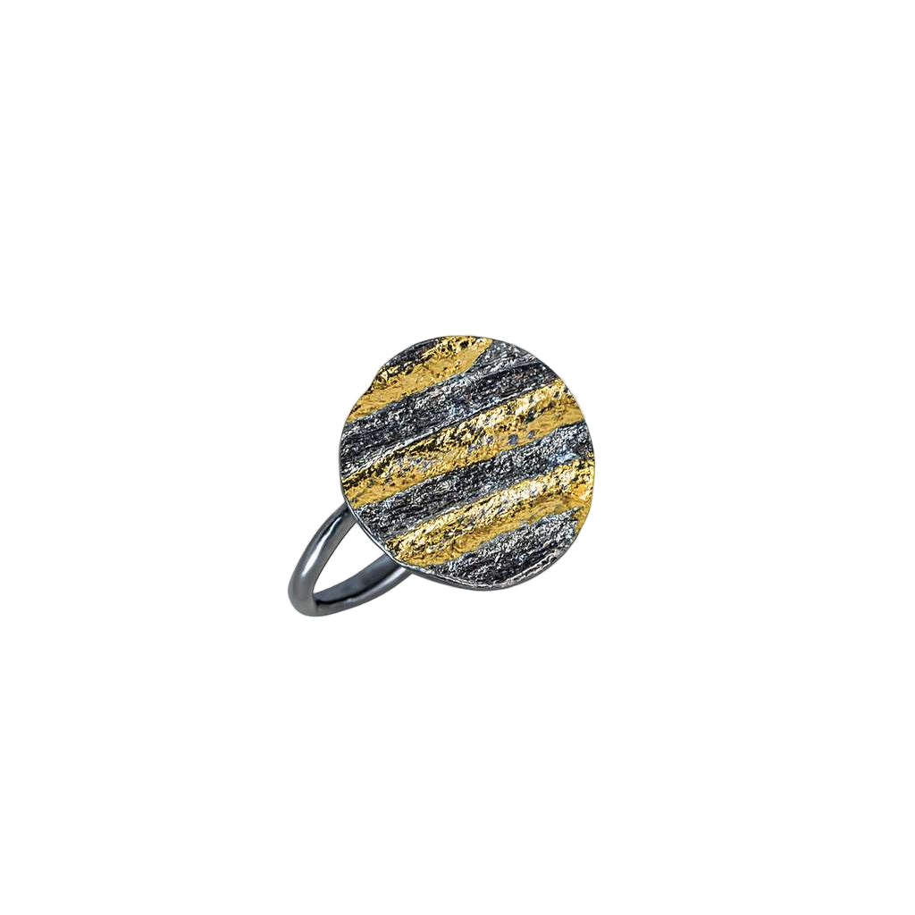 Ring with gold and black striped design on a white background